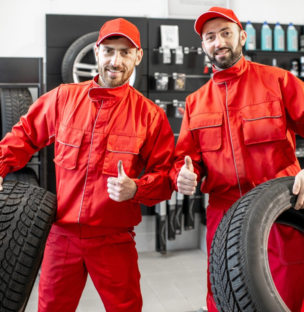 car-service-workers-with-new-tires-at-the-shop.jpg car-service-workers-with-new-tires-at-the-shop.jpg